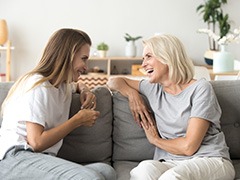 An older mother and young daughter chatting