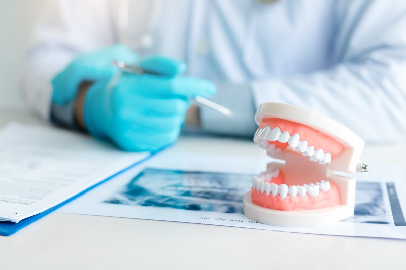 Mock dentures sitting on a dentist’s desk